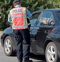 Police officer checking on a car
