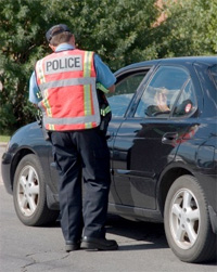 Police officer checking on a car