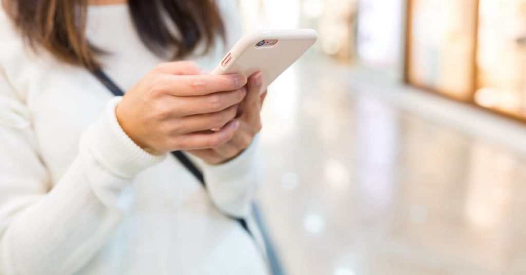 young woman holding cell phone