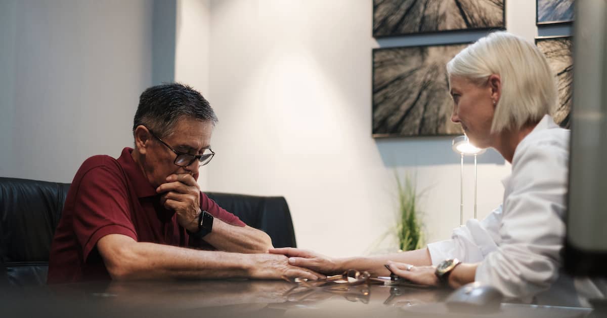 female doctor comforting male patient after diagnostic error