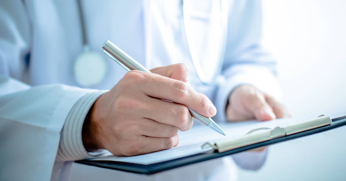 doctor filling out patient records