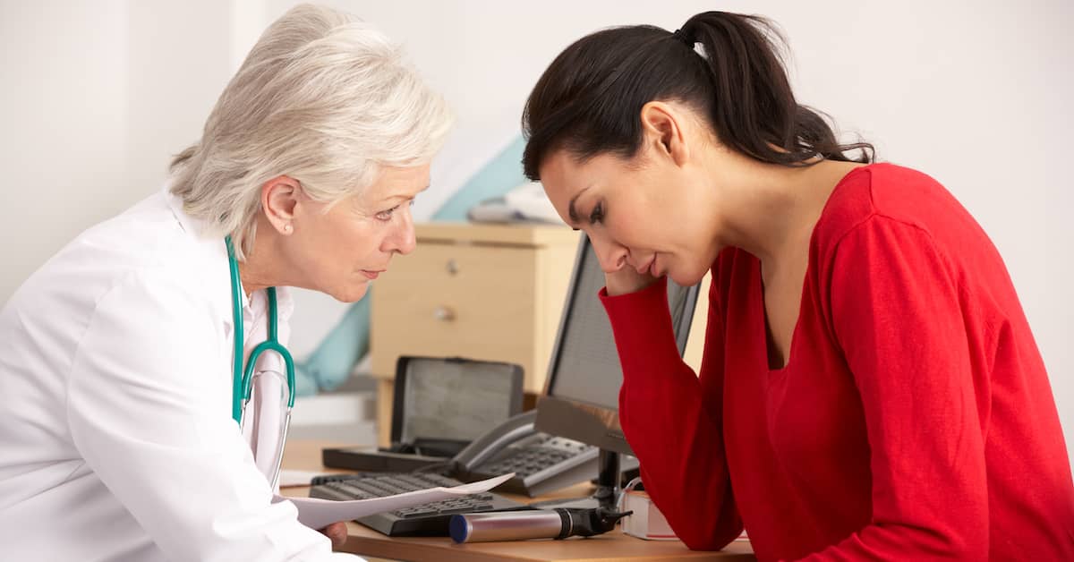 female doctor comforting female patient after bad news