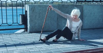 Older woman with cane after trip and fall accident on train platform | Klein Lawyers